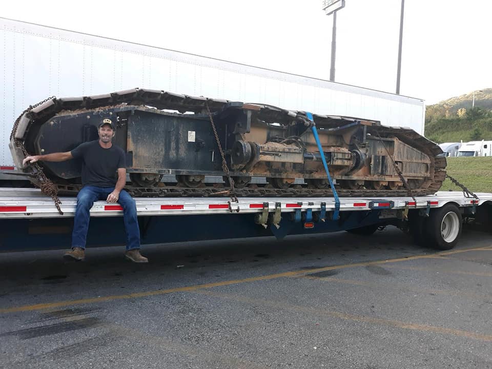 Owner of Stinger Trucking sitting on trailer